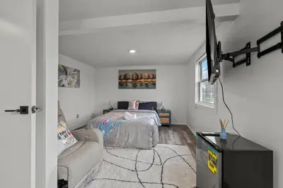a bedroom with a bed and a flat screen tv at Cosy house, home away from home in Grove City