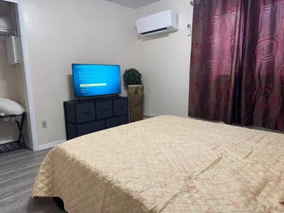 a bedroom with a bed and a flat screen tv at Apt Near Oberlin College in Oberlin