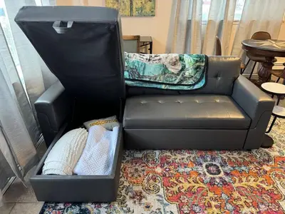 a black leather couch with pillows in a living room at Apt Near Oberlin College in Oberlin