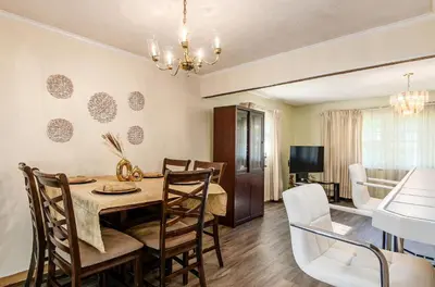a dining room and living room with a table and chairs at Gates getaway in Columbus