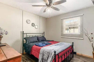 a bedroom with a bed with a ceiling fan at Gates getaway in Columbus