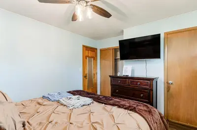 a bedroom with a bed and a flat screen tv at Gates getaway in Columbus