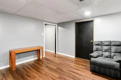 a room with a couch and a table and a door at Gates getaway in Columbus
