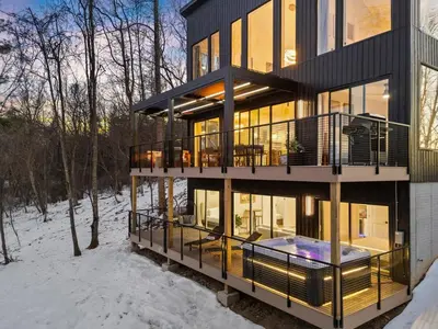 a large house with a deck in the snow at Adamina Canyon Luxurious, Canyon View 5BR, 3BTH 1 in Rockbridge