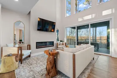 a living room with white furniture and a large window at Adamina Canyon Luxurious 5BR 3BTH 2 in Rockbridge