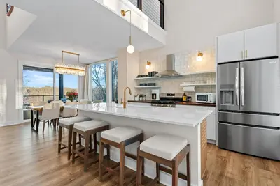 a kitchen with a large white island with bar stools at Adamina Canyon Luxurious, Canyon View 5BR 3BTH 3 in Rockbridge