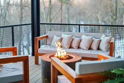 a couch sitting on a deck with a fire pit at Adamina Canyon Luxurious, Canyon View 5BR 3BTH 3 in Rockbridge