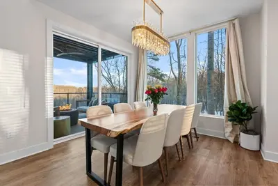 a dining room with a table and chairs and a large window at Adamina Canyon Luxurious Villa with Wellness room 5 in Rockbridge