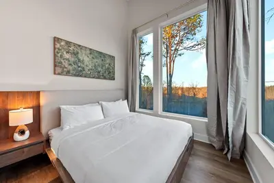 a bedroom with a bed and a large window at Adamina Canyon Luxurious Villa with Wellness room 5 in Rockbridge