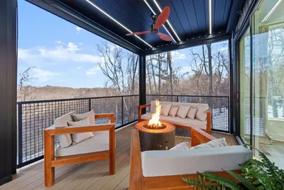 a screened in porch with a fire pit on a deck at Adamina Canyon Luxurious Villa with Wellness room 5 in Rockbridge