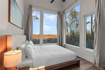 a bedroom with a bed and two large windows at Adamina Canyon Luxurious, Canyon View 5BR 3BTH- 6 in Rockbridge