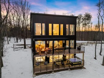 a black house in the snow in the woods at Adamina Canyon Luxurious, Canyon View 5BR 3BTH 8 in Rockbridge