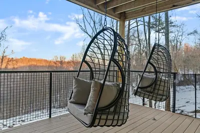 two hanging chairs on a porch with a view of the water at Adamina Canyon Luxurious, Canyon View 5BR 3BTH 8 in Rockbridge