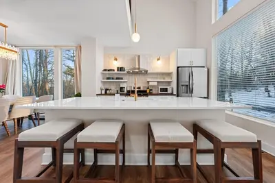 a kitchen with a large white island with stools at Adamina Canyon Luxurious, Canyon View 5BR 3BTH 8 in Rockbridge