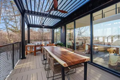 a screened in porch with a wooden table and chairs at Adamina Canyon Luxurious, Canyon View 5BR 3BTH 8 in Rockbridge