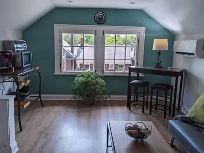 a living room with a table and a window at Bright Studio Stay Downtown in Columbus