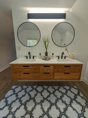 a bathroom with two sinks and two mirrors at Bright Studio Stay Downtown in Columbus