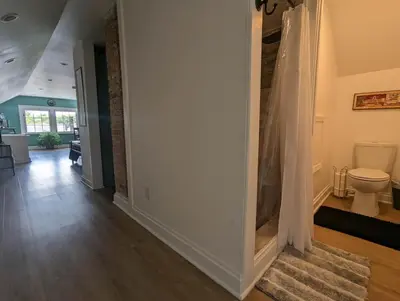 a hallway with a bathroom with a toilet in it at Bright Studio Stay Downtown in Columbus