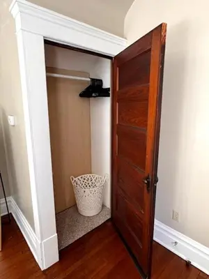 a closet with a wooden door in a room at Paisley Garden House Near Kings Daughters Hospital in Ashland