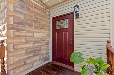 a red door on the side of a house at Paisley Garden House Near Kings Daughters Hospital in Ashland