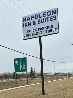 a sign on the side of a road at Napoleon Inn and Suites in Napoleon