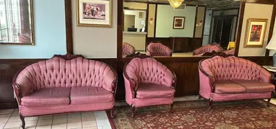 a row of pink chairs in a waiting room at Napoleon Inn and Suites in Napoleon
