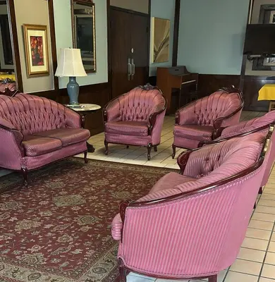 a group of pink chairs and chairs in a room at Napoleon Inn and Suites in Napoleon