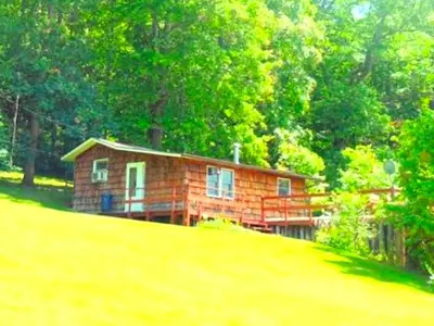 a small house on top of a hill at Rustic Cabin Rental near Akron, Ohio in Dellroy