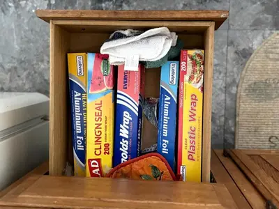 a wooden box with books on a table at Rustic Cabin Rental near Akron, Ohio in Dellroy