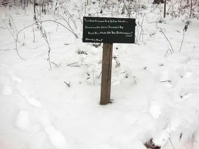 a sign in the snow on a trail at Rustic Cabin Rental near Akron, Ohio in Dellroy
