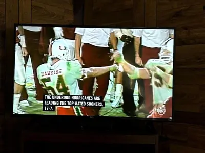 a television screen with a football player on it at Rustic Cabin Rental near Akron, Ohio in Dellroy