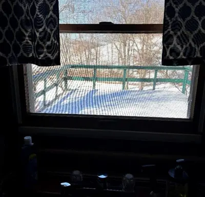 a window with a view of a bench seen through it at Rustic Cabin Rental near Akron, Ohio in Dellroy