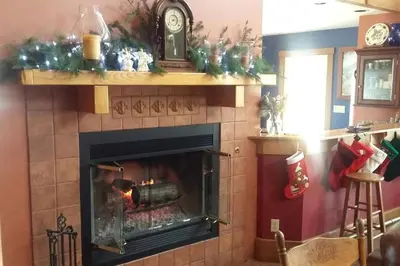 a living room with a fireplace with a fire place at Peaceful Getaway on a Lovely Farm near Hillsboro, Ohio