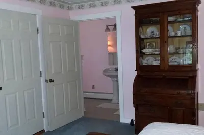a bedroom with a hutch and a sink in a bathroom at Romantic Room Rental on a Lovely Farm near Hillsboro, Ohio