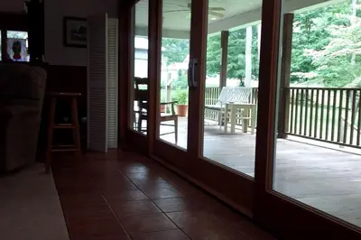 a screened in porch with sliding glass doors at Romantic Room Rental on a Lovely Farm near Hillsboro, Ohio