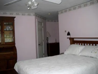 a bedroom with a white bed and a dresser at Romantic Room Rental on a Lovely Farm near Hillsboro, Ohio