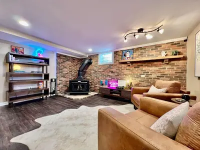 a living room with a couch and a fireplace at All the Vibes Poolside in Trenton in Trenton
