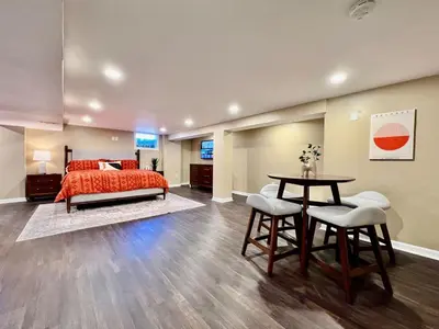 a bedroom with a bed and a table and chairs at All the Vibes Poolside in Trenton in Trenton