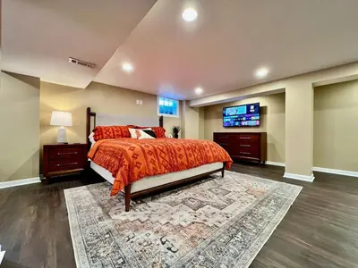 a bedroom with a bed and a flat screen tv at All the Vibes Poolside in Trenton in Trenton