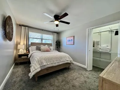 a bedroom with a bed and a ceiling fan at All the Vibes Poolside in Trenton in Trenton