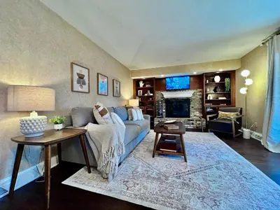 a living room with a couch and a fireplace at All the Vibes Poolside in Trenton in Trenton