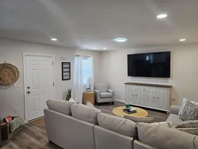 a living room with a couch and a flat screen tv at Cozy New Const. Ranch Near Park in Middletown