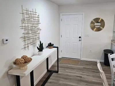 a white living room with a table and chairs at Cozy New Const. Ranch Near Park in Middletown