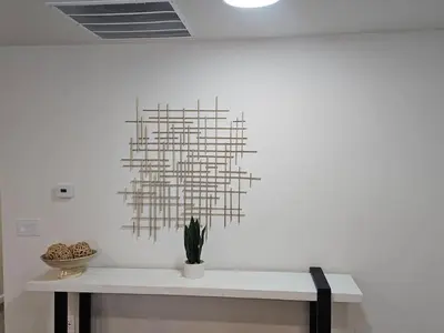 a white wall with a sculpture on top of a table at Cozy New Const. Ranch Near Park in Middletown