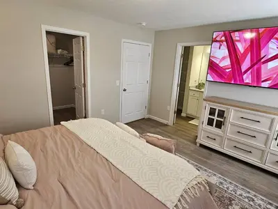 a bedroom with a bed and a flat screen tv at Beautiful NEW Wilmington Ranch in Wilmington
