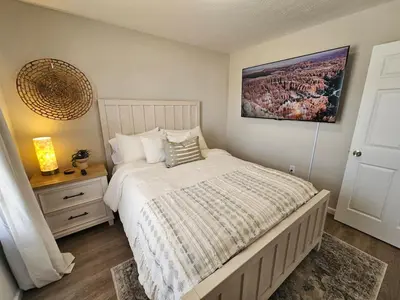 a bedroom with a bed and a picture on the wall at Beautiful NEW Wilmington Ranch in Wilmington