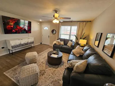 a living room with a leather couch and chairs at Beautiful NEW Wilmington Ranch in Wilmington