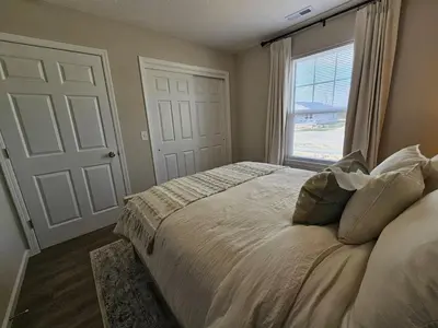 a bedroom with a large bed with a window at Beautiful NEW Wilmington Ranch in Wilmington