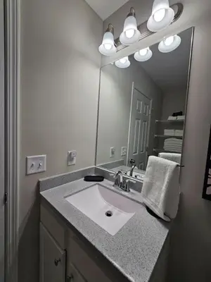 a bathroom with a sink and a large mirror at Beautiful NEW Wilmington Ranch in Wilmington