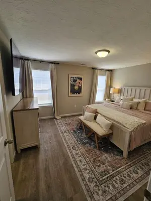 a bedroom with a large bed and a table at Beautiful NEW Wilmington Ranch in Wilmington